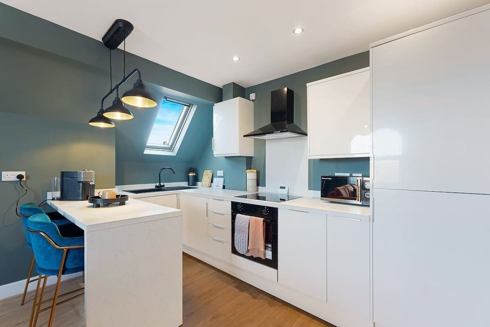A fully equipped kitchen with all essentials, including an oven, fridge, and a complete cookware set, perfect for convenient home-style cooking during your stay.