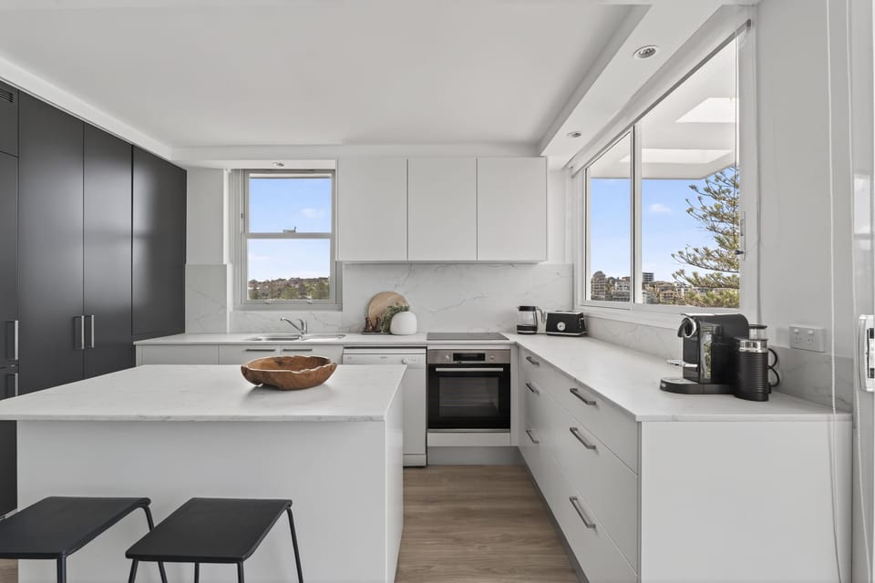 Kitchen with coffee maker, oven, stove, microwave, dishwasher