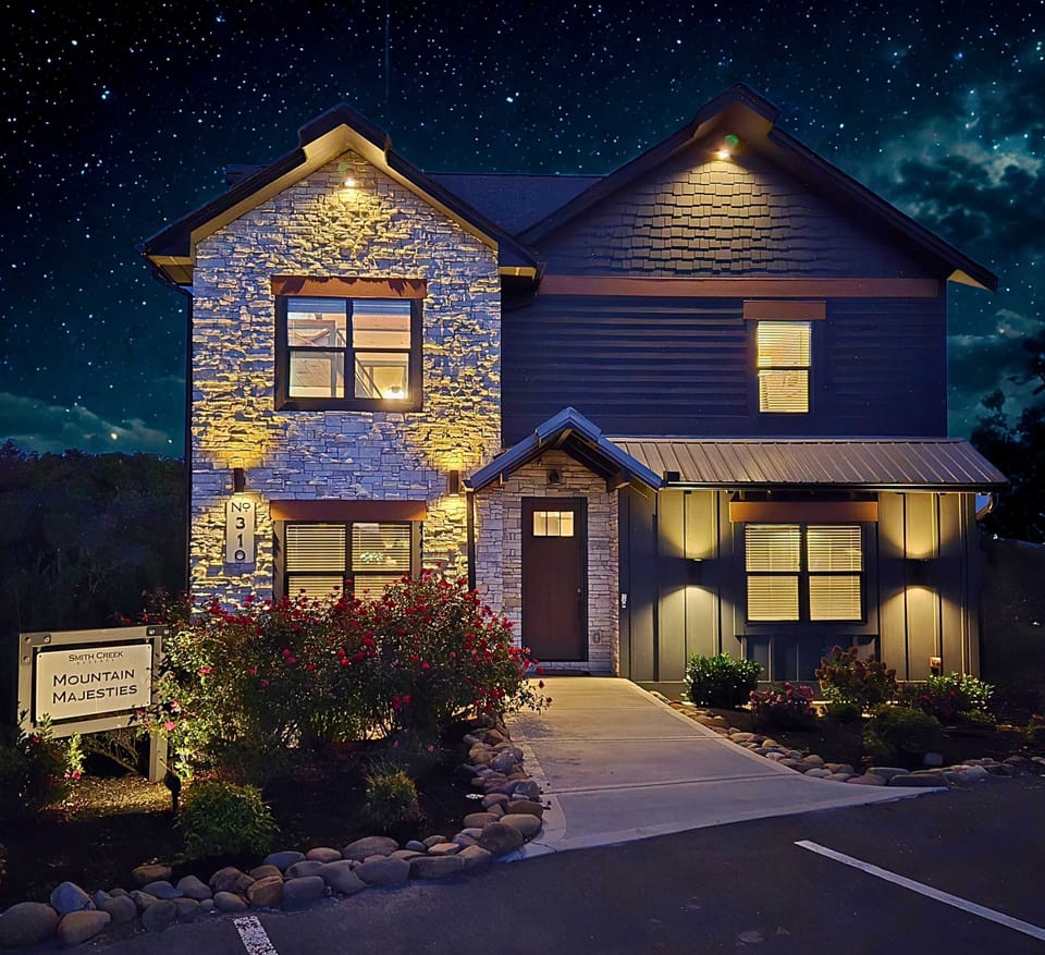 Pull in after dark and the Mountain Majesties sign lights your way to the front door — home base for the whole week starts right here.