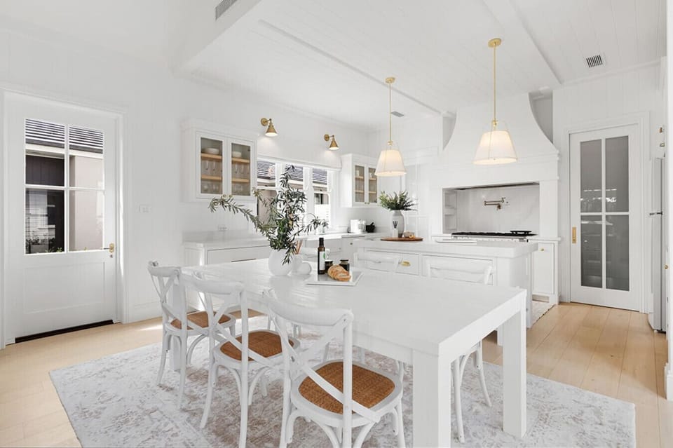 Light-filled kitchen, with large island bench and separate casual dining for eight. Fully equipped for group stays. Including Gran Lattissima coffee machine, country electric oven with gas stove top and dishwasher with easy access to full laundry.