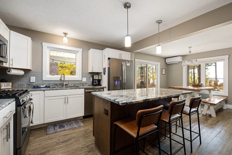 Open kitchen w/ large island, bar seating & seamless flow into the dining area.