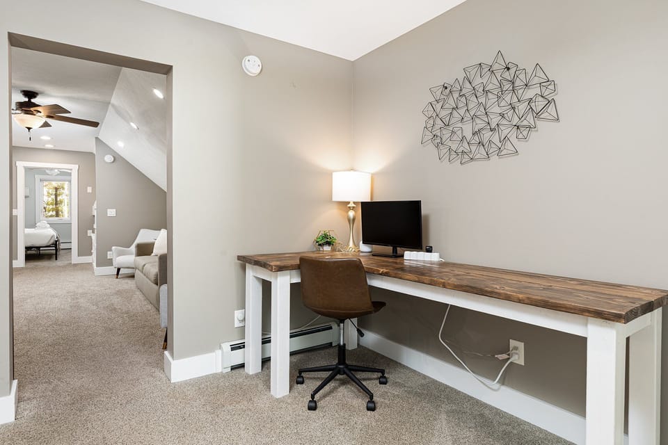 Dedicated workspace w/ long desk & comfy chair, ideal for remote work or planning the day.