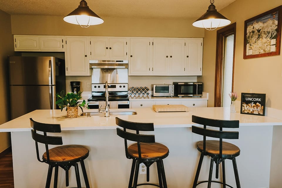 Fully stocked kitchen featuring counter seating and ample space for cooking.