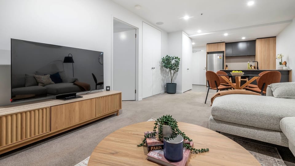 Spacious lounge with smart TV and stylish furnishings.