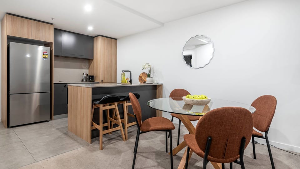 Dining area with seating for four beside the modern kitchen.