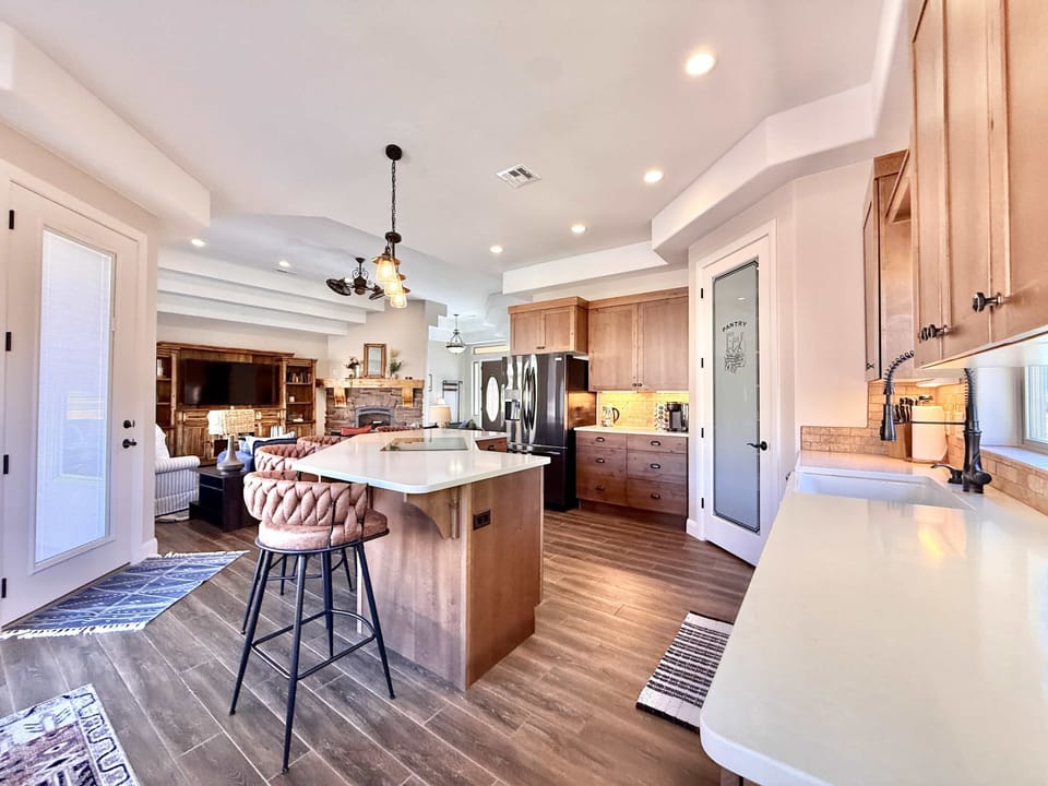 The fully equipped kitchen blends seamlessly with the large living room which makes gathering with friends and family easy and fun.