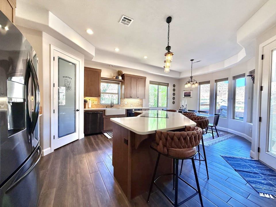 The kitchen features top of the line appliances and a large kitchen bar with seating.