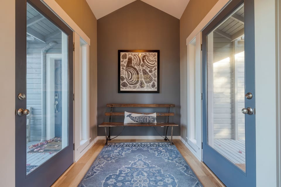 Hallway with wall art and bright natural light.