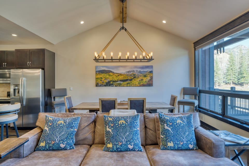Open-concept living and dining area with vaulted ceilings.