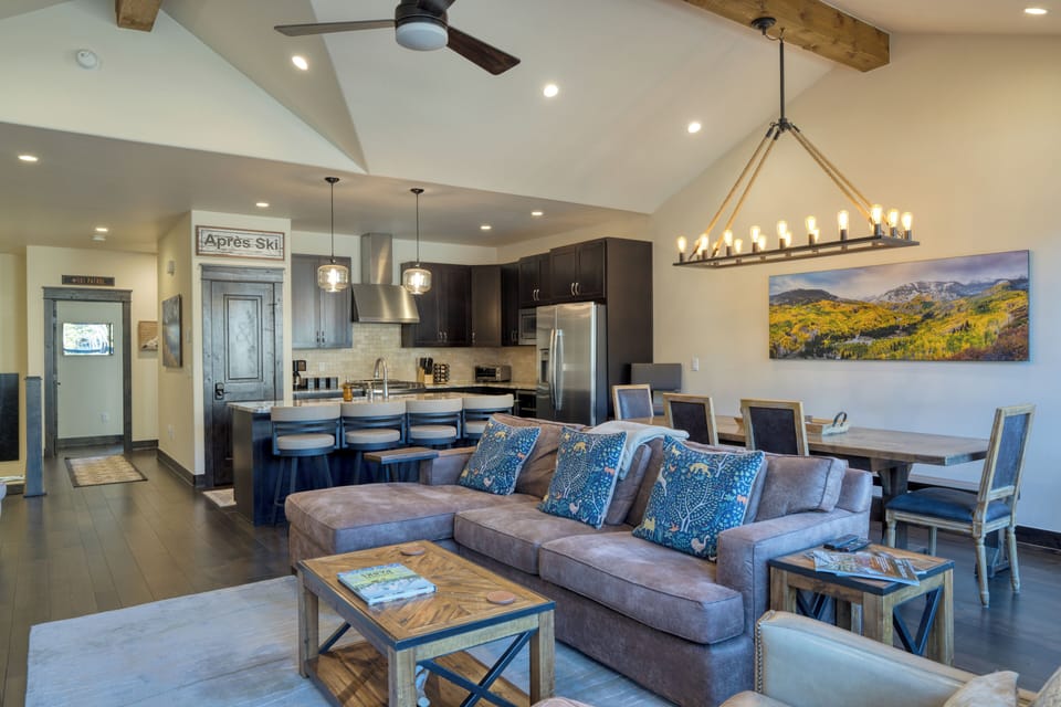 Spacious living room with fireplace and open kitchen layout.