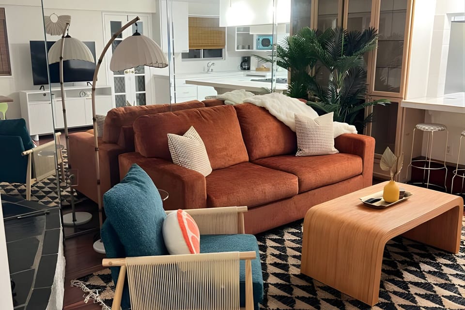 Living room w/ warm sofa + blue pillows