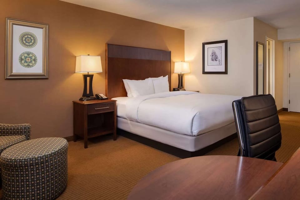 King bed with soft lighting and cozy seating area