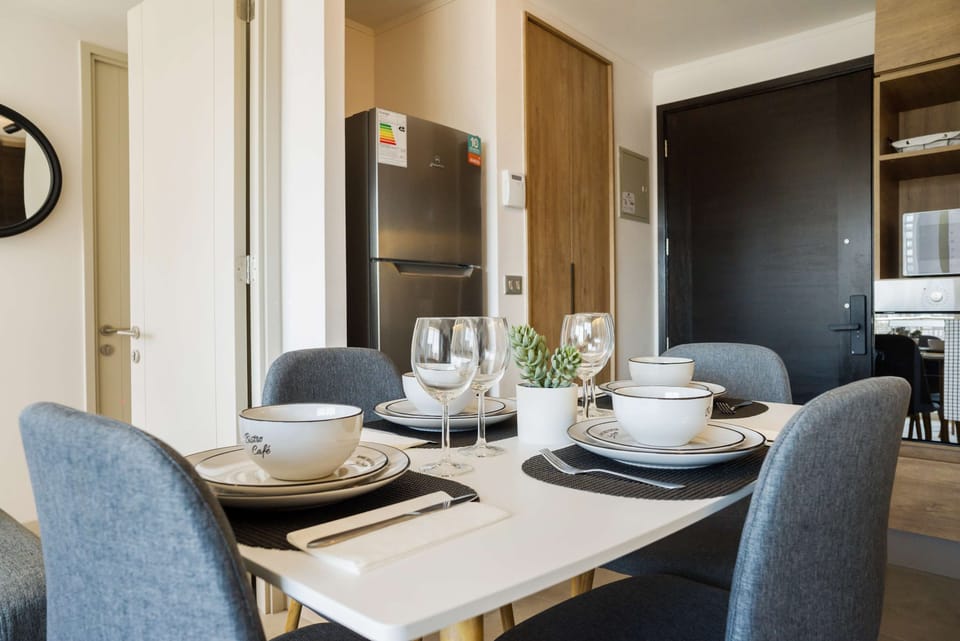Modern dining area with stylish table setting, perfect for enjoying meals in comfort and style.