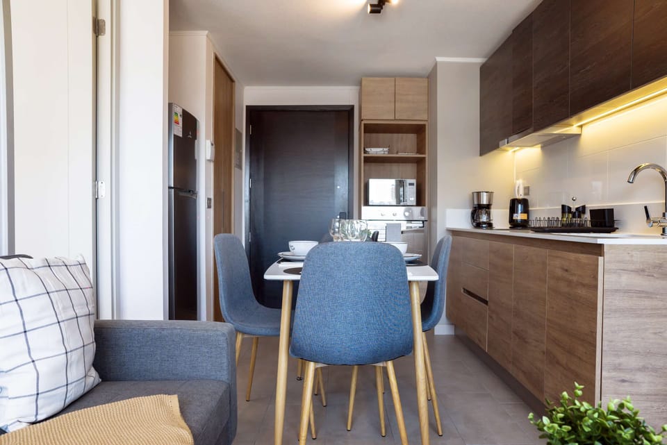 Cozy kitchen and dining area with modern amenities, perfect for intimate meals in your private apartment studio.