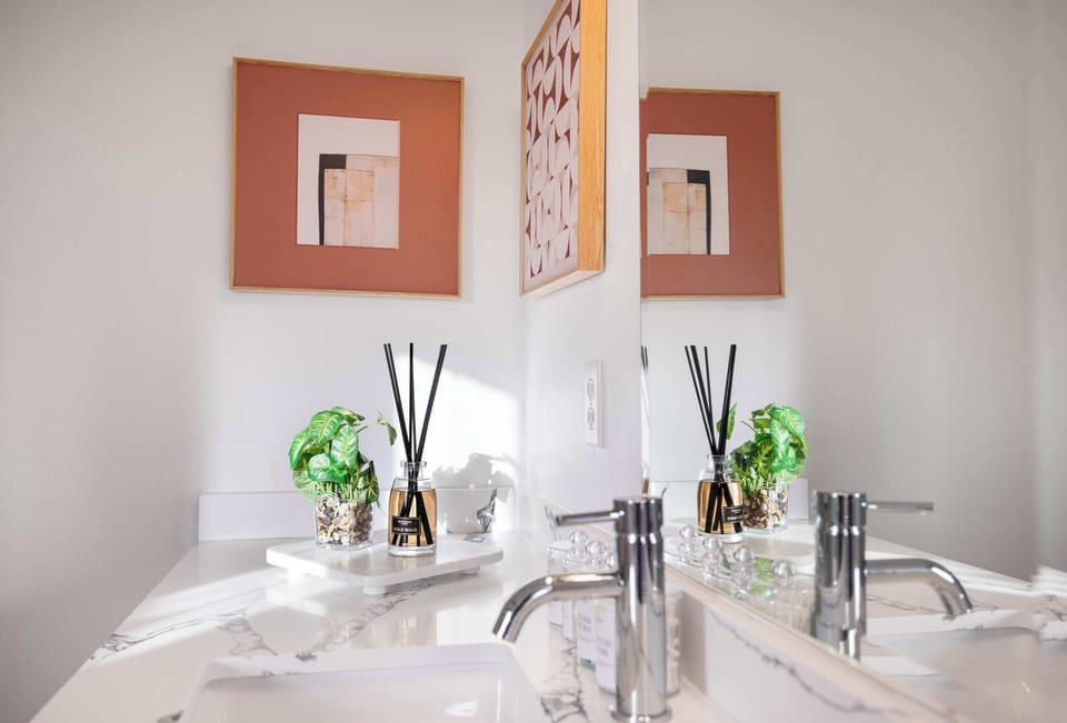 Chic vanity setup with greenery and soft lighting.