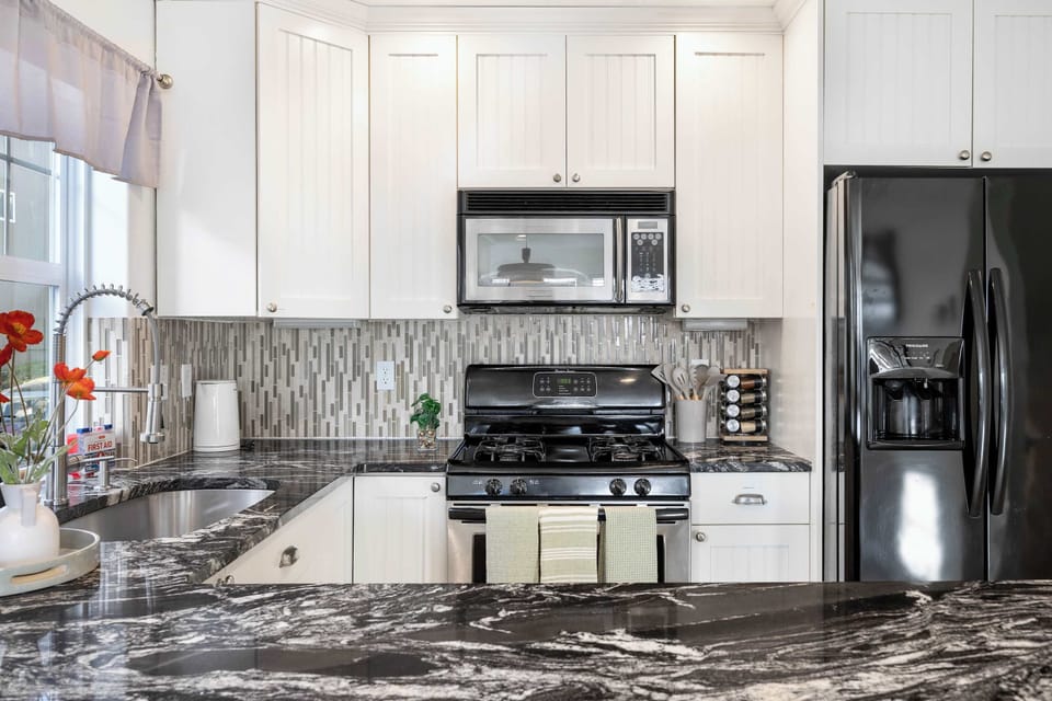 Modern cooking space featuring stainless steel appliances and gas stove.
