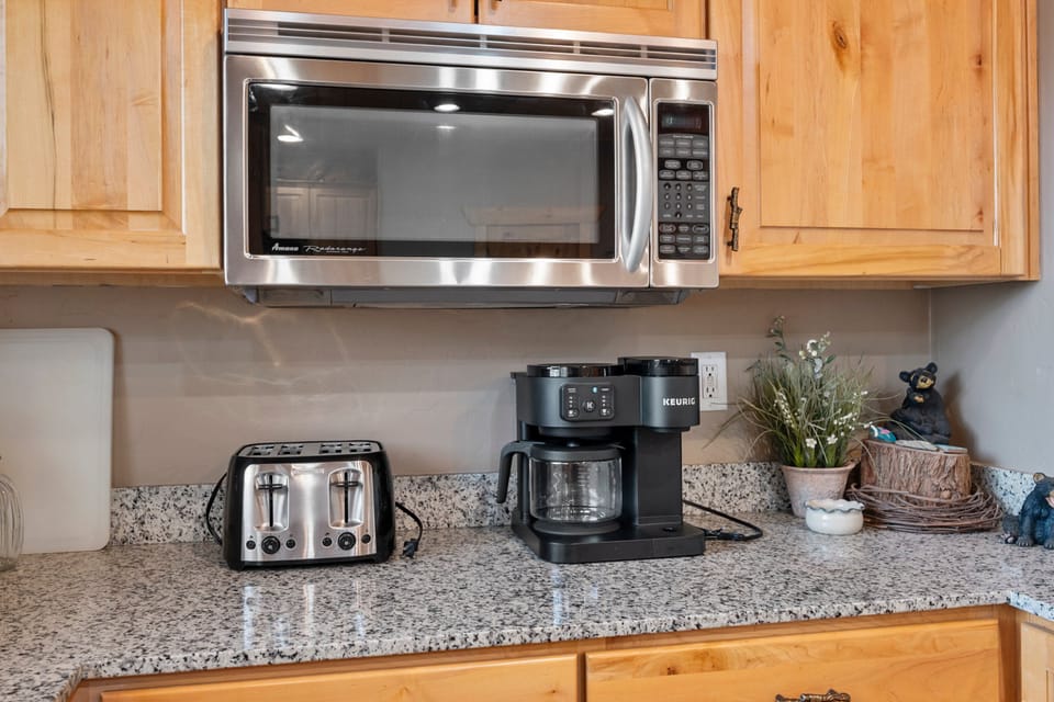 The large kitchen is fully equipped and includes a kitchen island with bar seating.