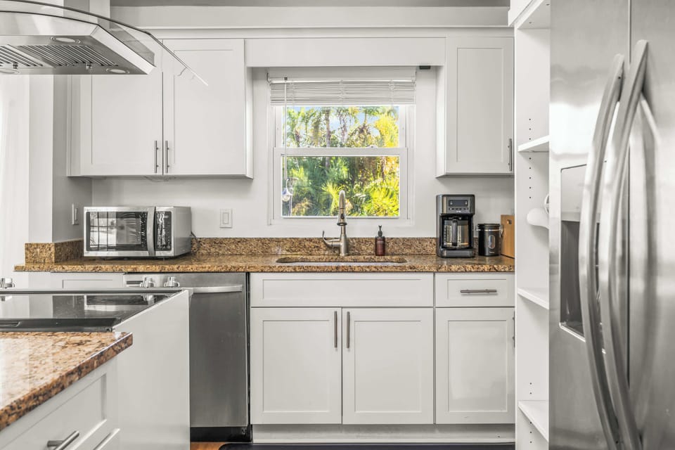 White shaker cabinets, granite counters, and a window over the sink keep this kitchen bright and functional. - Kitchen - The Palm - West Palm Beach, FL