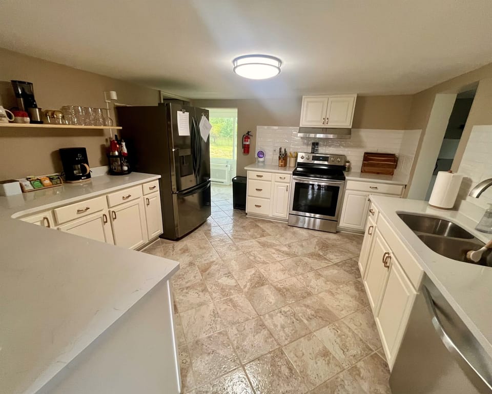 Where do you love to cook big breakfasts, family dinners, and have late-night laughs? Our fully equipped kitchen! - cookware, dinnerware, extras crockpots, ice cream maker,  pop corn maker and ninja indoor grill, spices and paper essentials. 