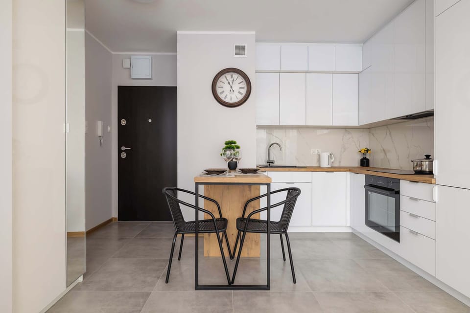 The bright kitchen with a wooden countertop and large table encourages shared meals and creates a pleasant spot for morning coffee.