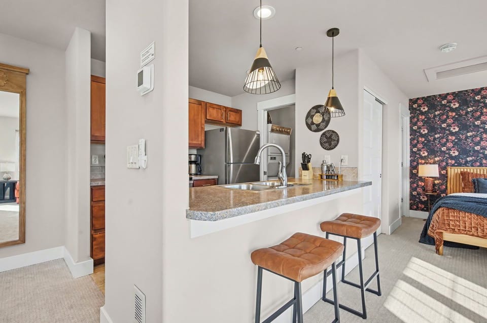 Your stylish kitchen awaits with granite counters, stainless appliances, and leather bar stools—perfect for morning coffee or evening cocktails.