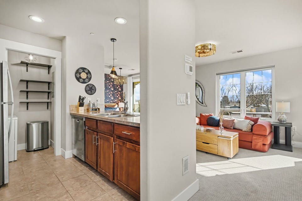 Your stylish open-plan living space seamlessly blends modern comfort with warm touches, featuring a fully equipped kitchen and cozy lounge.