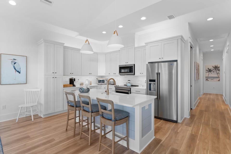 Your spacious kitchen invites culinary adventures with gleaming countertops, modern appliances, and a perfect breakfast bar for morning coffee moments.