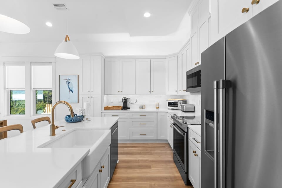 Your fully equipped gourmet kitchen features stainless steel appliances, marble countertops, and elegant white cabinetry for memorable cooking experiences.
