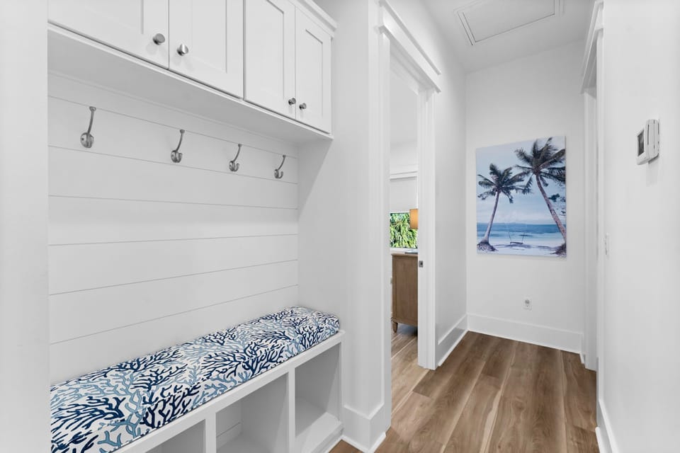 Your coastal-themed entryway welcomes you with built-in seating and storage, perfect for settling in after beach adventures.