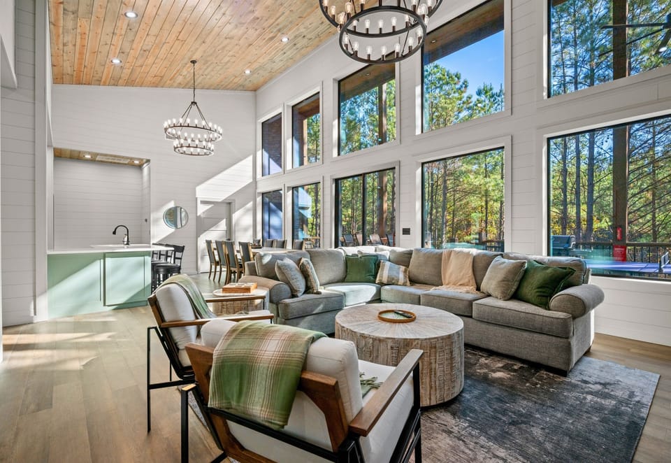 The open-concept living room is filled with natural light and cozy seating, making it the perfect place to unwind, watch a movie, or enjoy time together.