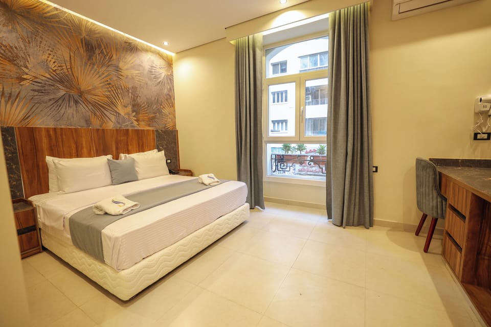 Deluxe Double Room, City View | Minibar, in-room safe, desk, soundproofing