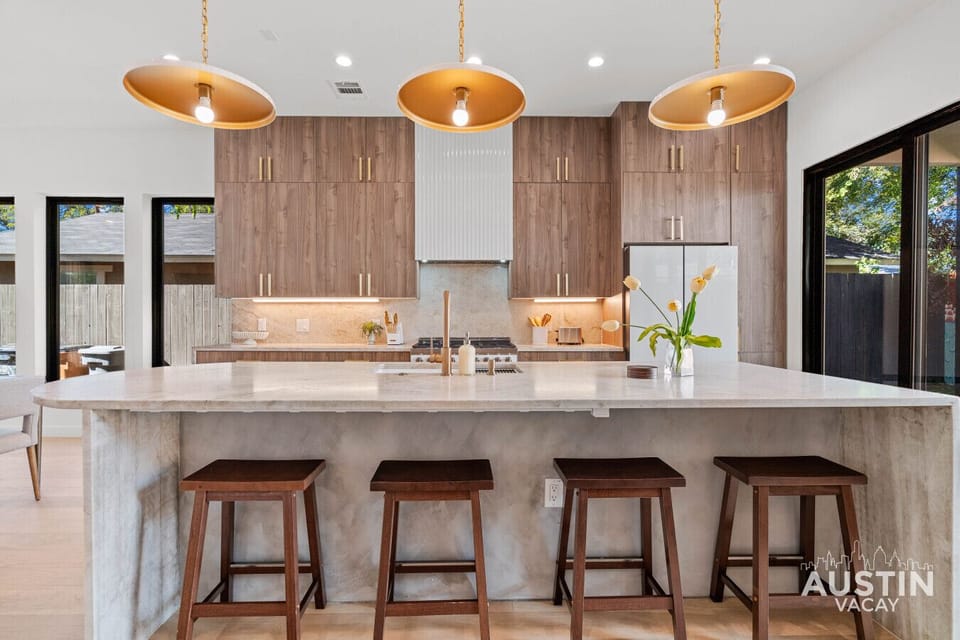 Marble, mood lighting, and morning light—your dream kitchen just showed up.”
