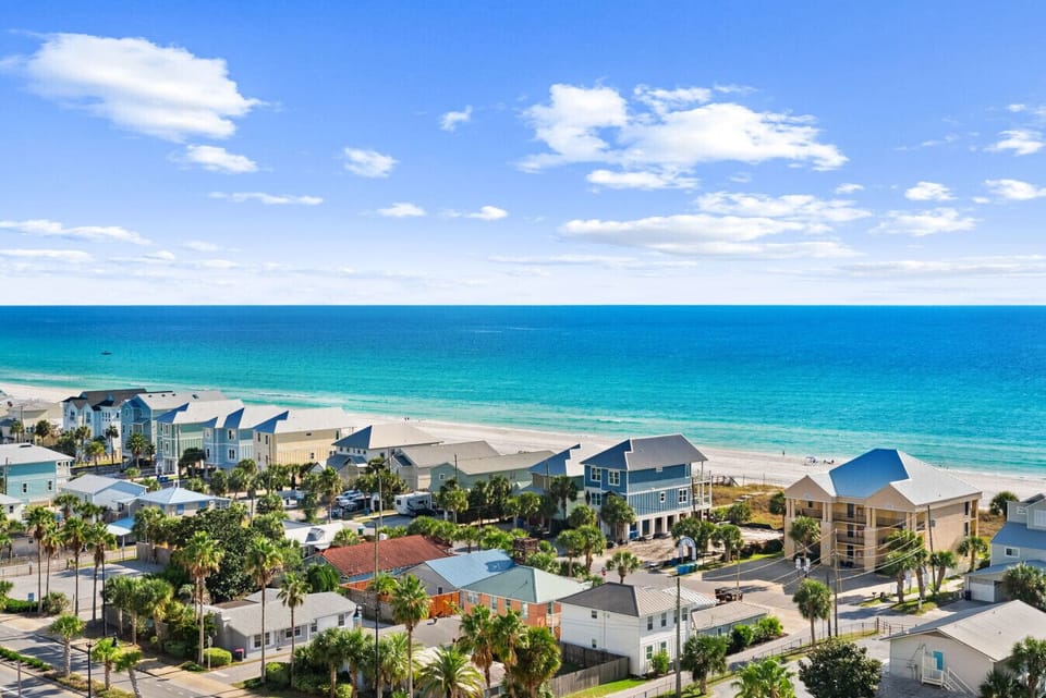 Balcony Ocean View – Left: Breathtaking Gulf views overlooking charming coastal homes and emerald waters.
