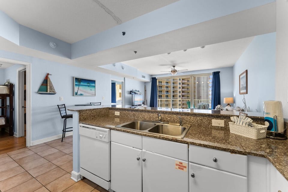 Spacious granite countertops with sightline straight to the balcony and ocean beyond.