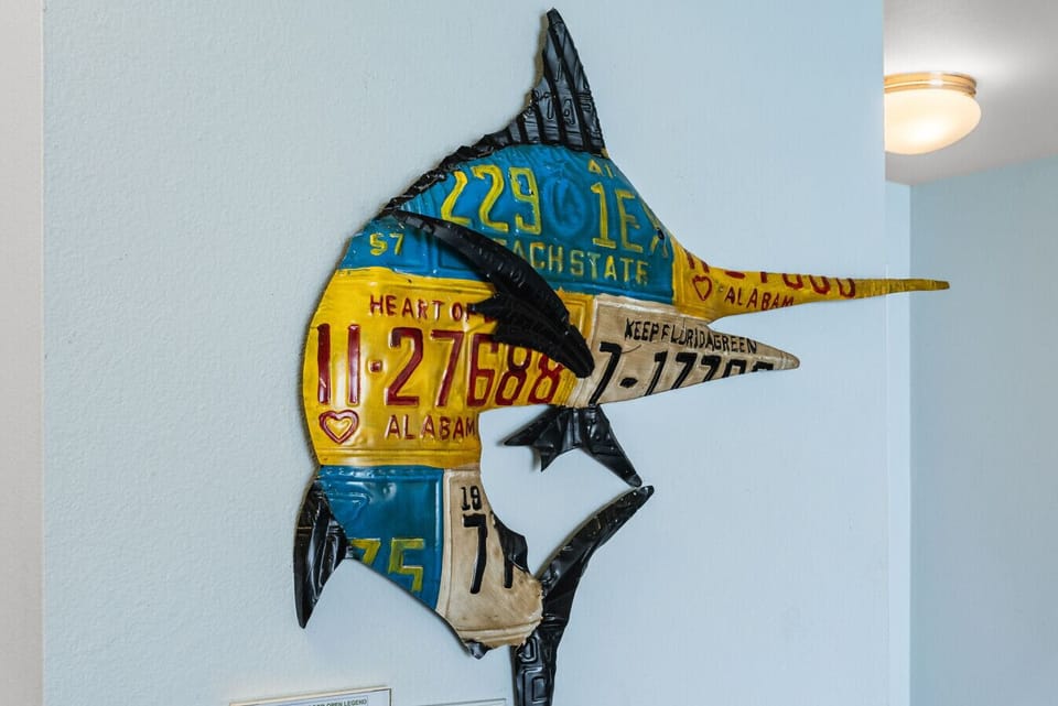 Nautical marlin sculpture made from vintage license plates adds a fun coastal touch.