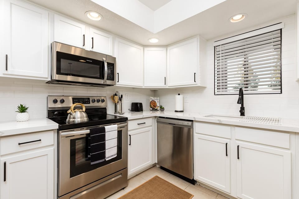 Bright, modern kitchen with stainless steel appliances and sleek cabinetry