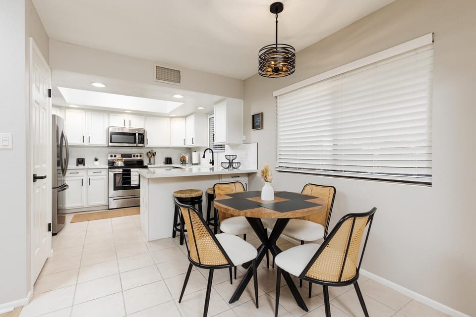 Bright dining nook with modern kitchen and cozy seating