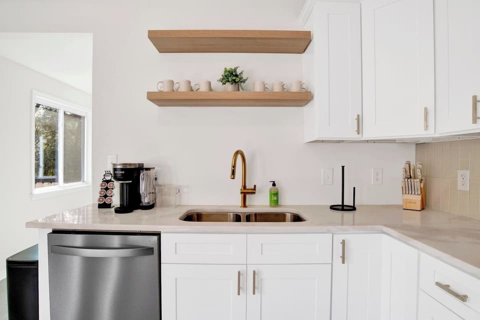 Fully equipped kitchen with stainless steel appliances, coffee bar, and dining space for family meals or work breaks.