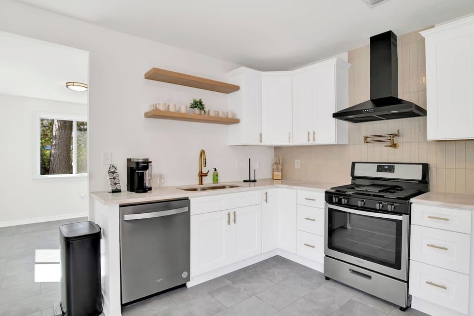 Fully equipped kitchen with stainless steel appliances, coffee bar, and dining space for family meals or work breaks.