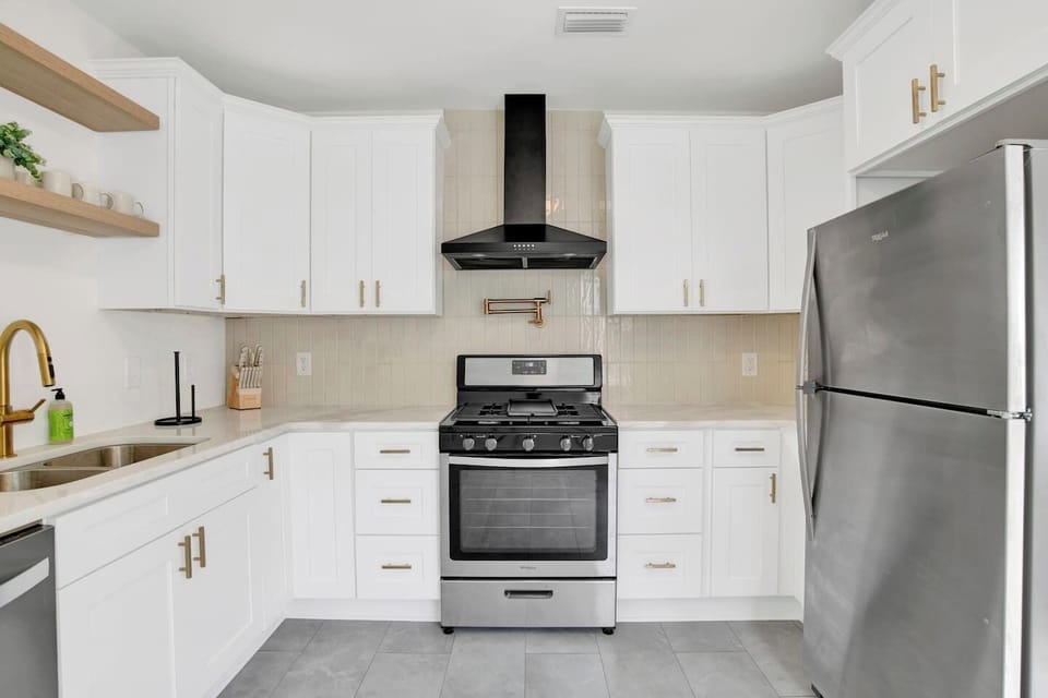 Fully equipped kitchen with stainless steel appliances, coffee bar, and dining space for family meals or work breaks.
