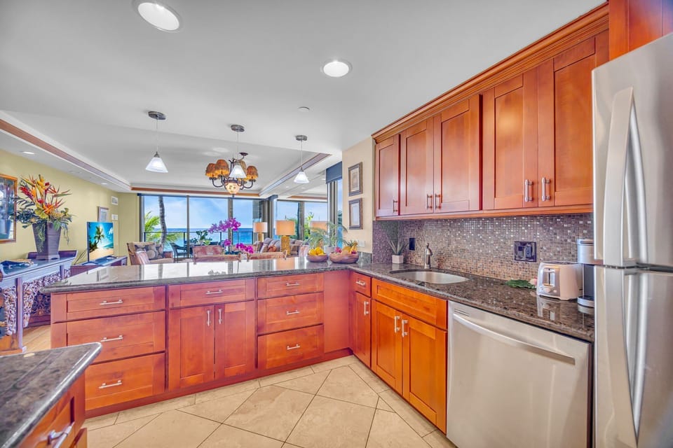 Cook with ease in a modern kitchen featuring polished granite countertops, ample storage, and stainless steel appliances