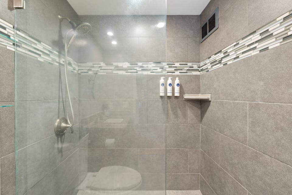 Contemporary walk-in shower with glass enclosure and detailed tilework for a spa-like feel.