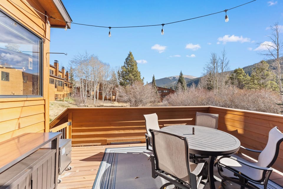 Soak up mountain views from your private deck, where string lights create perfect ambiance for morning coffee or evening relaxation.