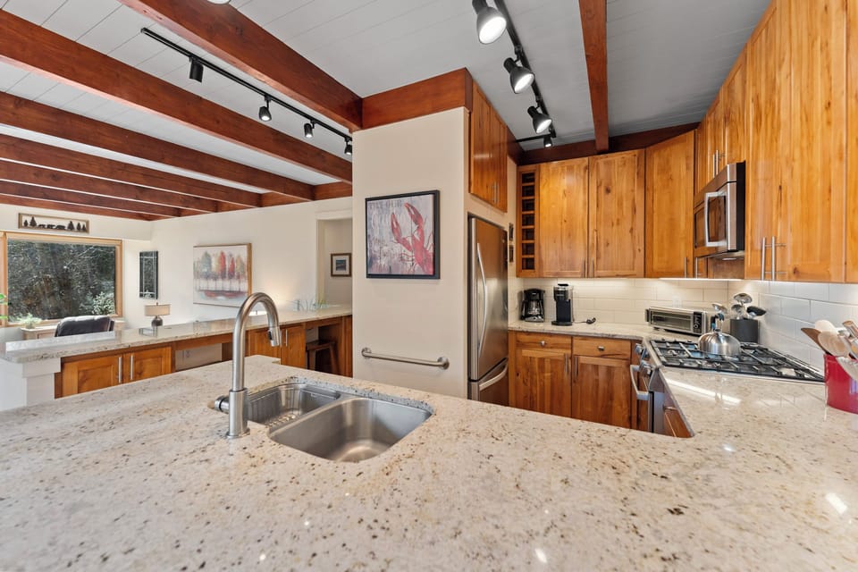 Prepare your favorite meals in this stunning kitchen featuring granite countertops, rich wood cabinets, and modern stainless steel appliances.