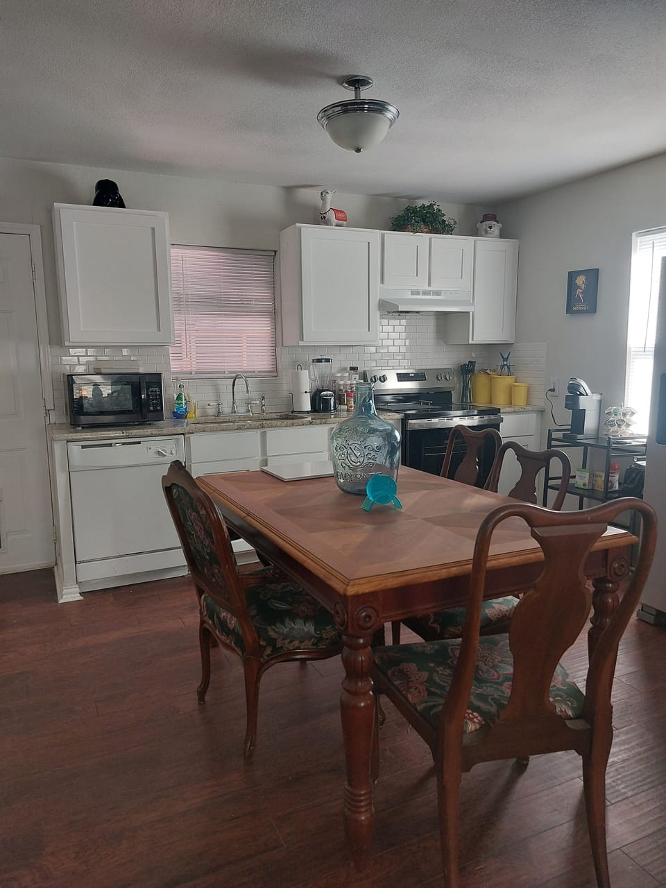 New stove, Keurig coffee maker. 
Kitchen has dishes and cookware. 