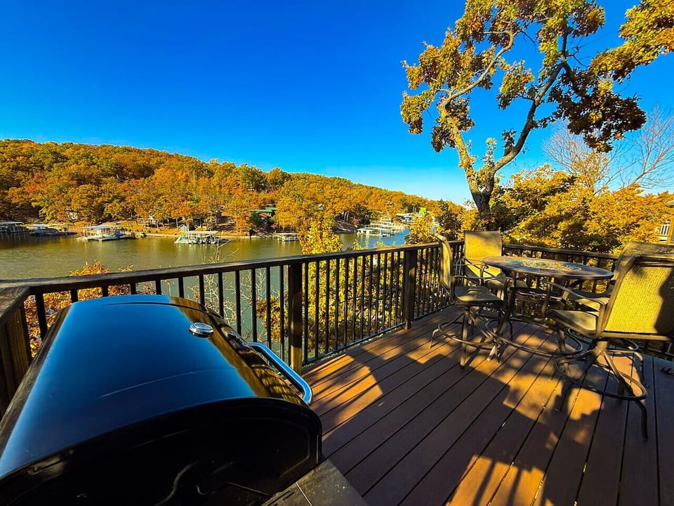 Private deck overlooking the lake — complete with BBQ grill and outdoor seating for dining with a view.