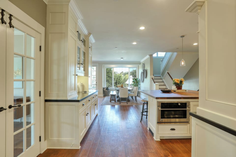 The foyer leads directly into the home's main central hub: the great room, kitchen, and the fabulous outdoor entertaining deck.