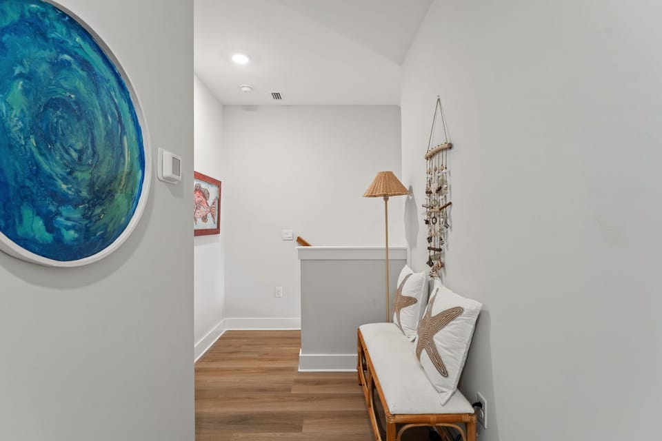 Relax in your bright coastal retreat with ocean-inspired art, warm wood floors, and thoughtful nautical touches throughout.