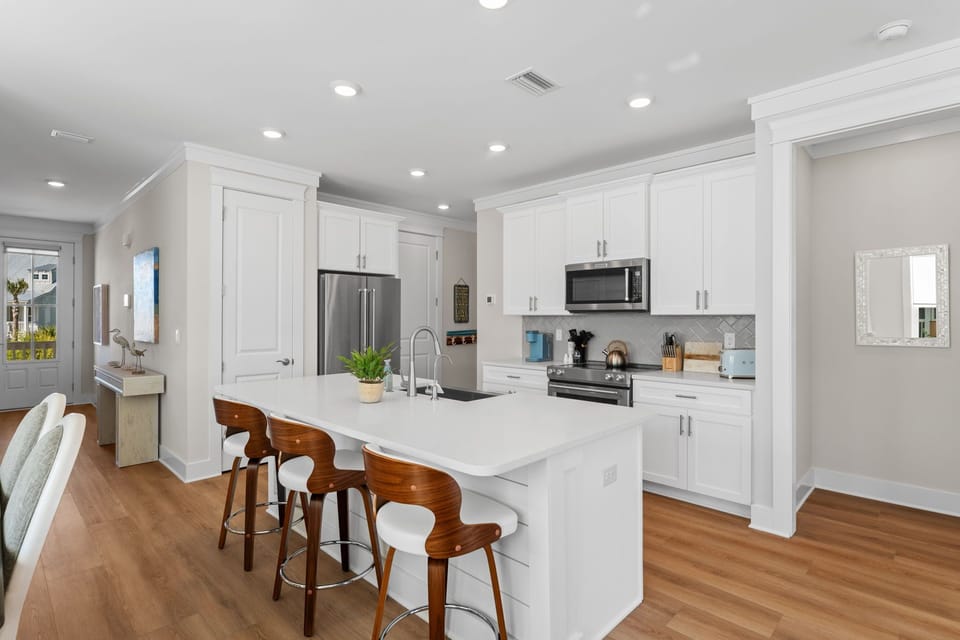 Your fully equipped kitchen features a spacious island, modern appliances, and stylish bar seating—perfect for cooking memorable meals together.