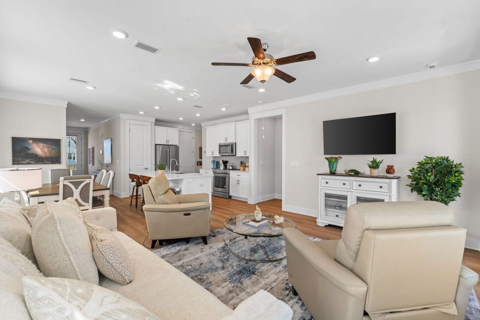 Relax in your spacious open-concept living area with plush seating, modern kitchen, and entertainment center—perfect for unwinding after exploring.